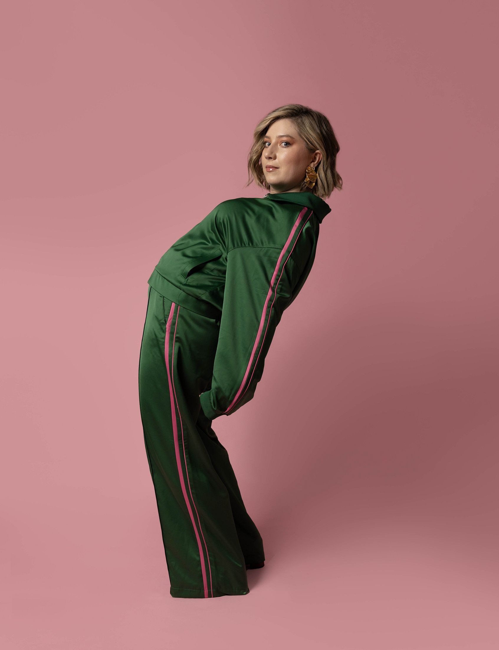 Harriett in a green tracksuit, bending backwards